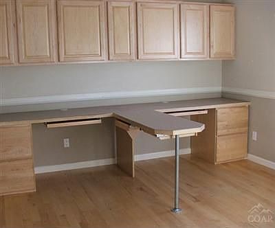 Home office with built in cabinets and desk