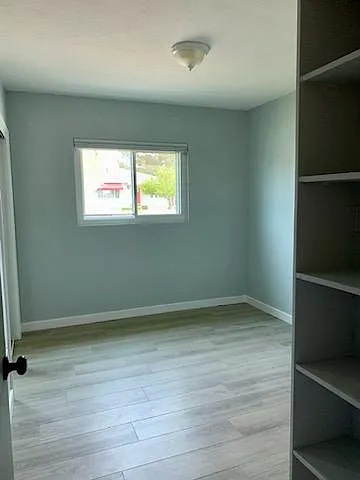 Bedroom #1 with mirrored 2'x5' closet & built-in bookshelf