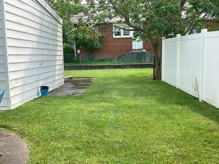 side yard with garage on left