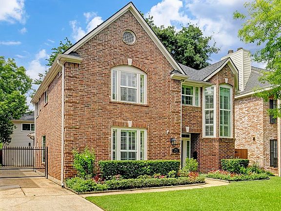 Lovely brick on a tree lined street with many large high end homes surrounding it.