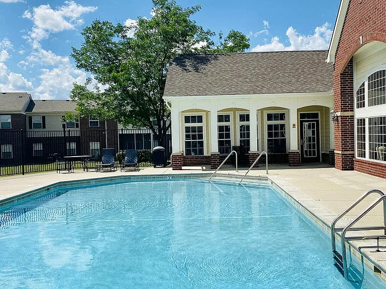 Dive into relaxation at The Bristol's inviting outdoor pool and spacious sundeck _ a perfect spot to unwind under the sun in Camby, IN.