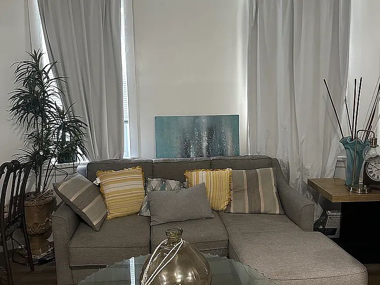 Spacious living room with 10 ft ceiling.