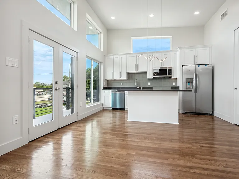 Large windows for lots of natural light in the kitchen/living area. Custom cabinetry and stainless steel appliances.
