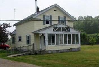 Here you can see the nice front sunporch on this home and there is a ramp into this home if needed. 
