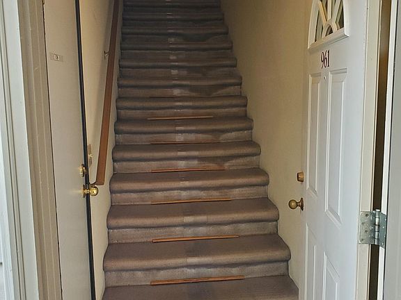 Stairs to apartment, garage door on left
