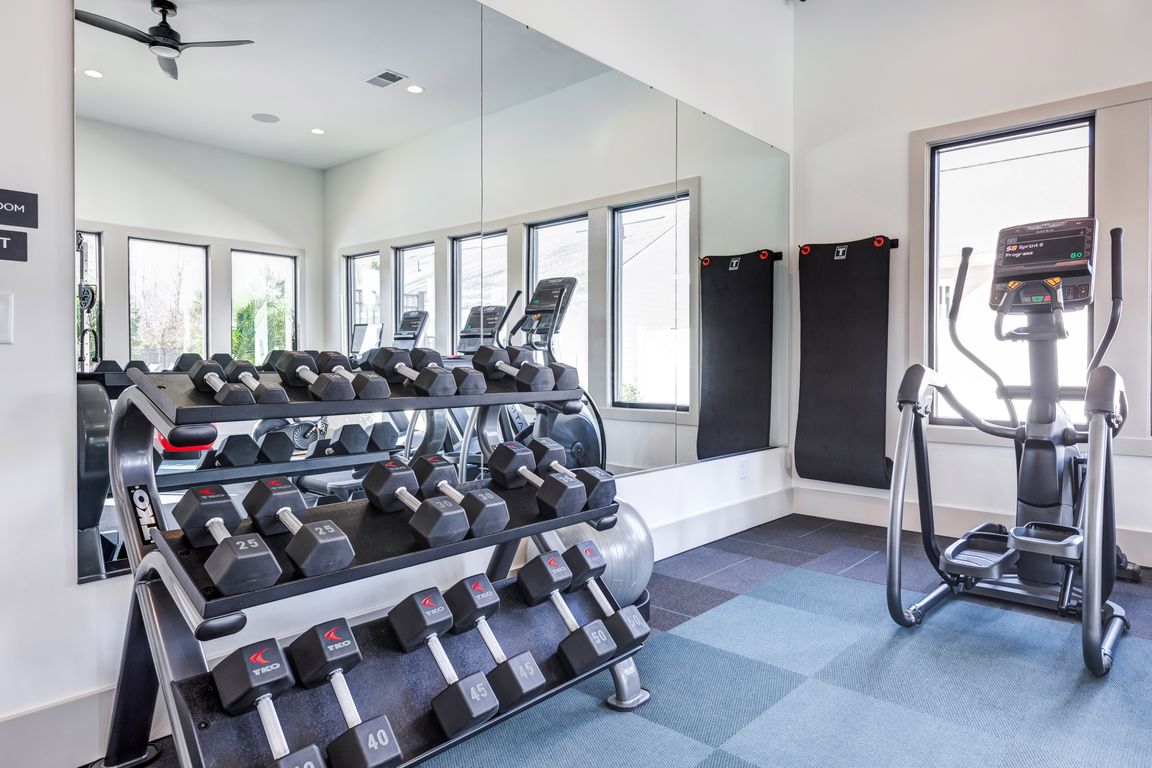 Club-quality fitness studio with free weights and elliptical. This image is a representation of the fitness studio at Amavi Brier Creek and is tentatively scheduled to open Summer 2025.