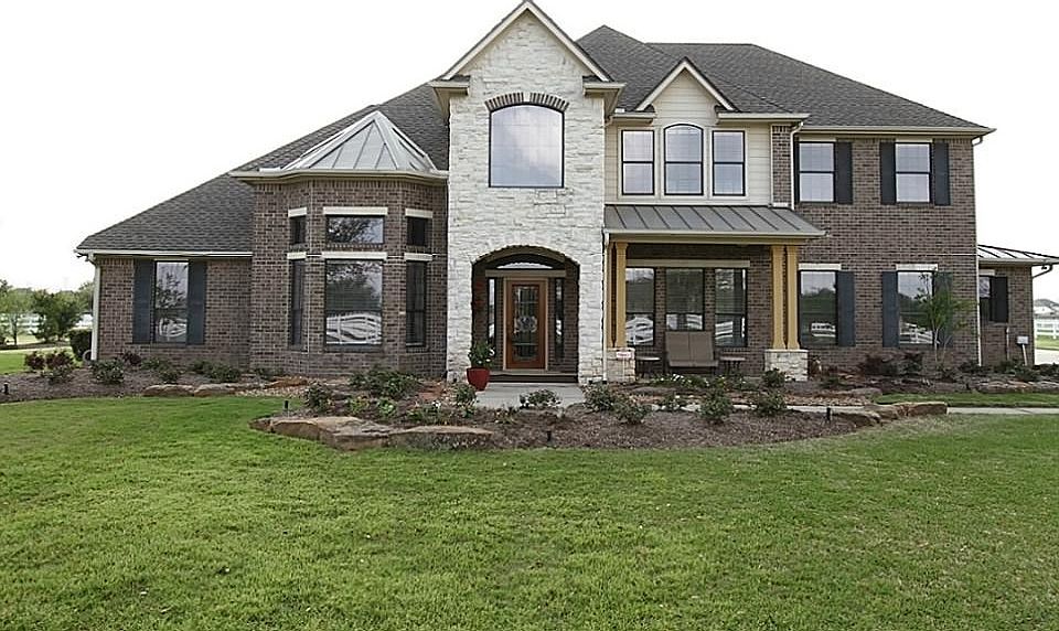 . Brick and Stone exterior with a composition and metal roof