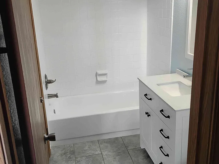 Main bathroom tub and tile surround have been refinished. New plumbing fixtures and fittings.
