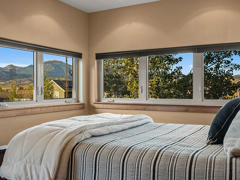 Queen guest room with Bridger Mountain views and walk-in closet.