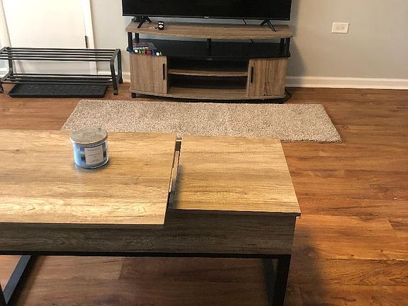 Living room with lift top coffee table and 55 inches smart tv