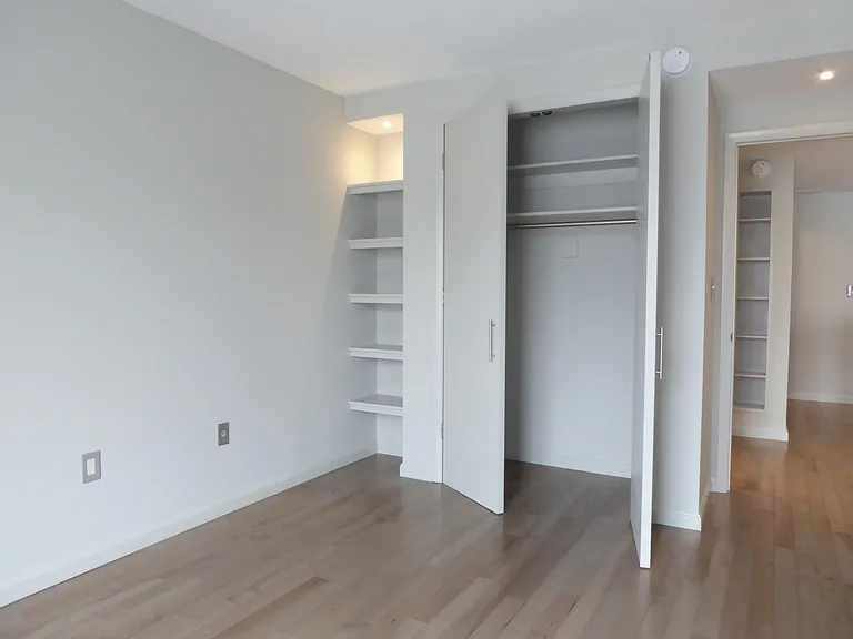 Large bedroom with ample closet space and stylish built-ins.