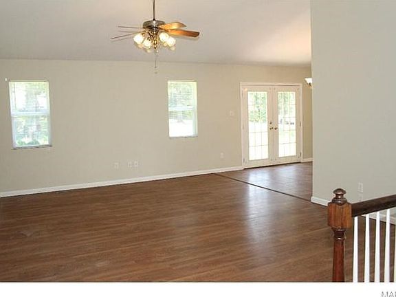 View from the living room entry foyer to the back of the home.  Check out the french door leading out to the patio and large flat back backyard.