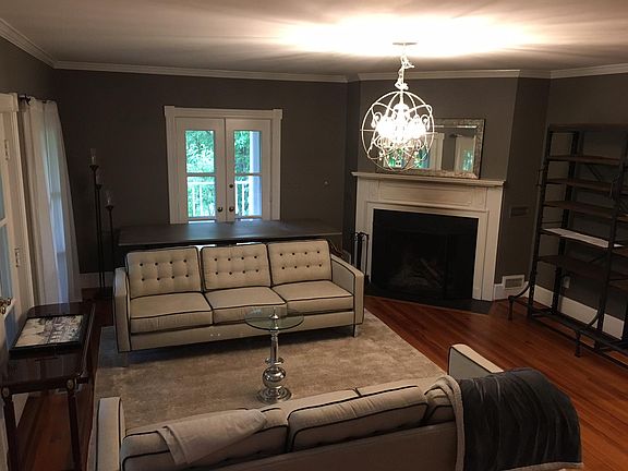 formal living room with wood-burning fireplace