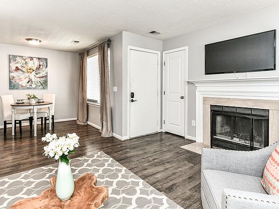 Open-concept living/dining space. Wood-burning fireplace.