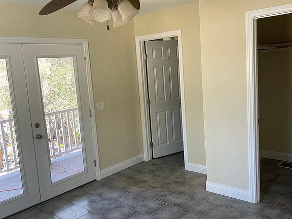 Second bedroom with a view French doors that lead to the wraparound porch. Also a walk in closet