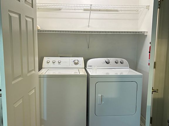 Full size W/D behind doors adjacent to kitchen