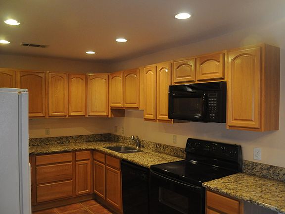 Bright, modern kitchen with wood cabinets and granite countertops.
