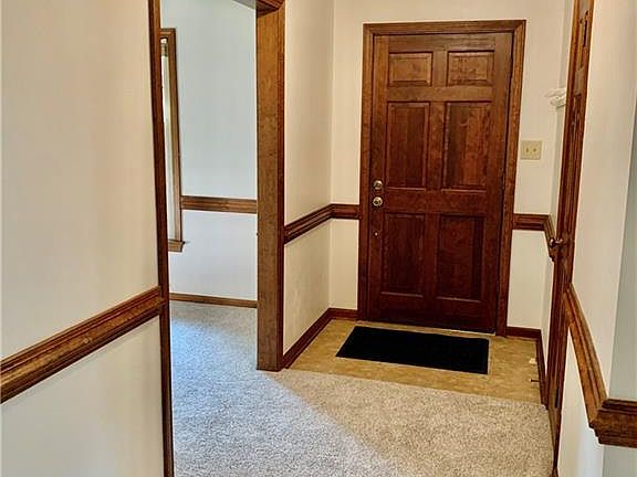 Ceramic tiled entry foyer with updated light fixture, and crown molding