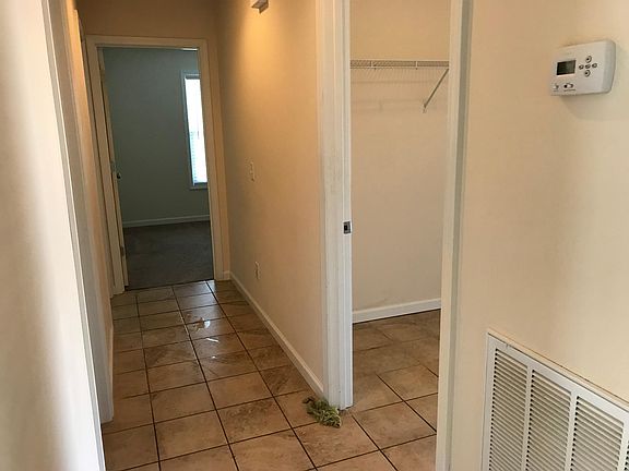 Hall way with washer/dryer room on the right