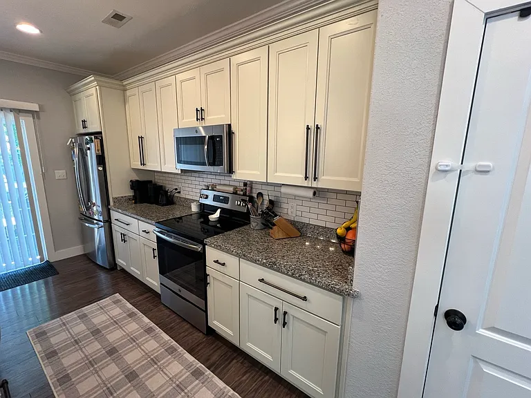 Galley style kitchen with subway tile, soft close drawers and cabinets