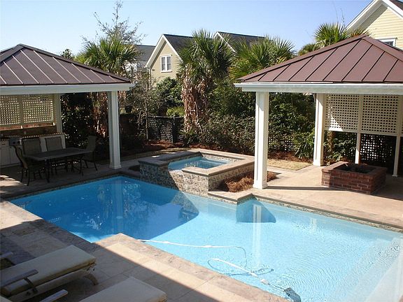 Backyard Oasis with pool, gas firepit, covered outdoor kitchen and hot tub.