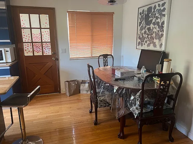 Side door and breakfast nook in the kitchen. The house will be rented with as much of its existing furniture as the tenants want.