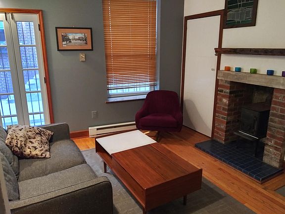 Living room with fireplace and coat closet