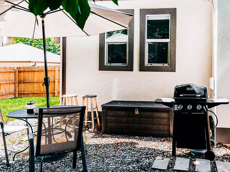 Fully fenced-in backyard. Patio area with umbrella under the Catalpa trees. BBQ grill. Grassy area for your pup!