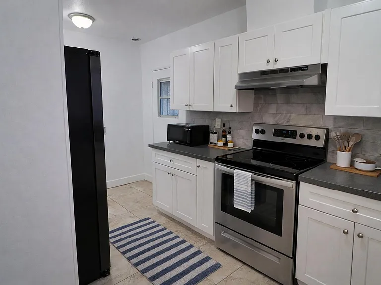 Kitchen includes a stove, refrigerator and microwave.