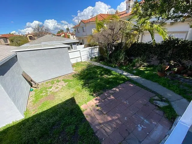 view of the yard and property entrance from the front door.