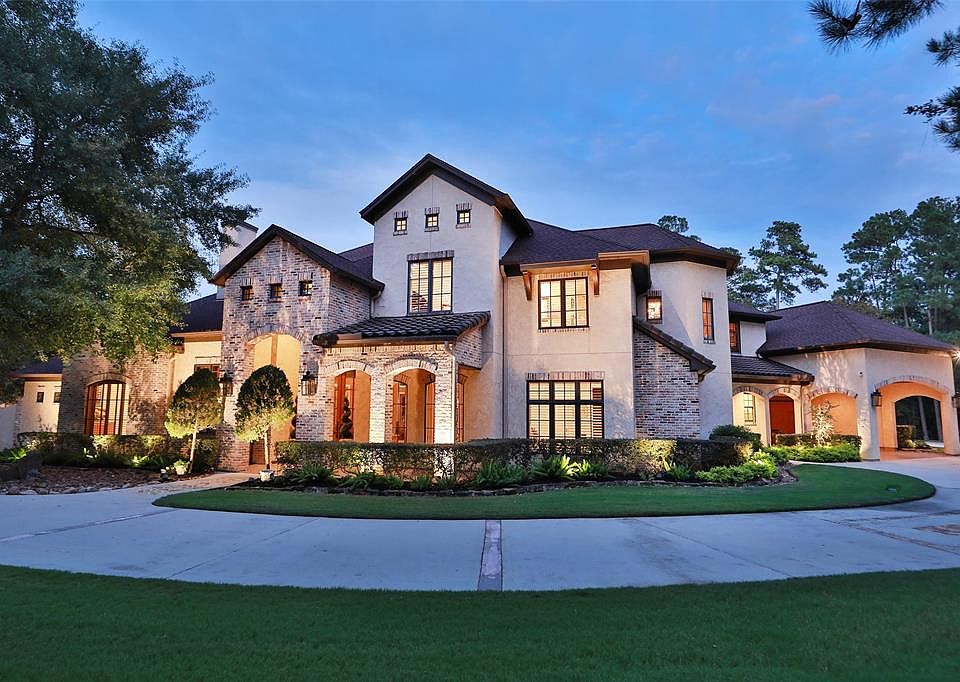 Presenting 28222 Meadow Falls with a view of the Front Exterior W/ Beautiful Landscape Lighting throughout the property