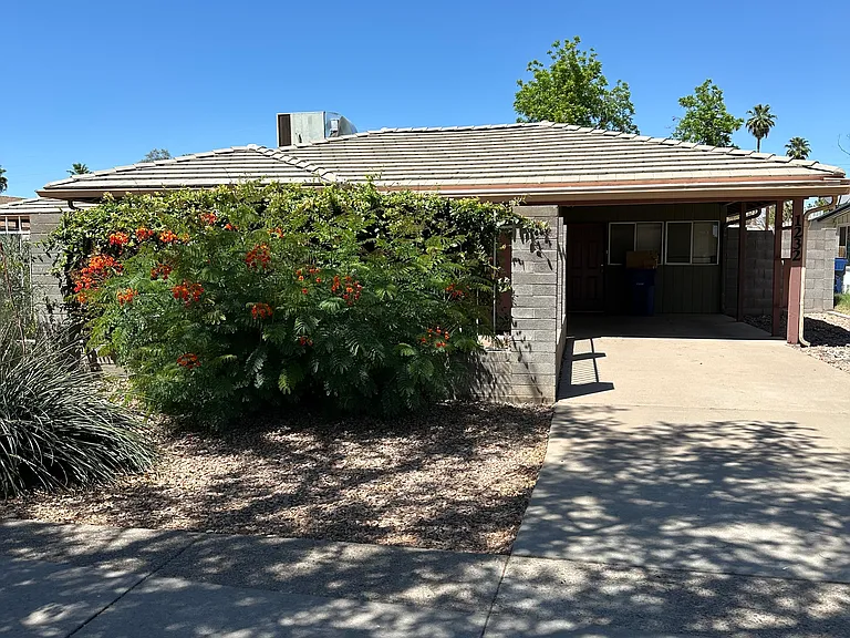 Front view of unit and carport