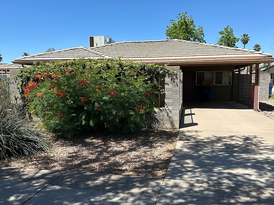 Front view of unit and carport