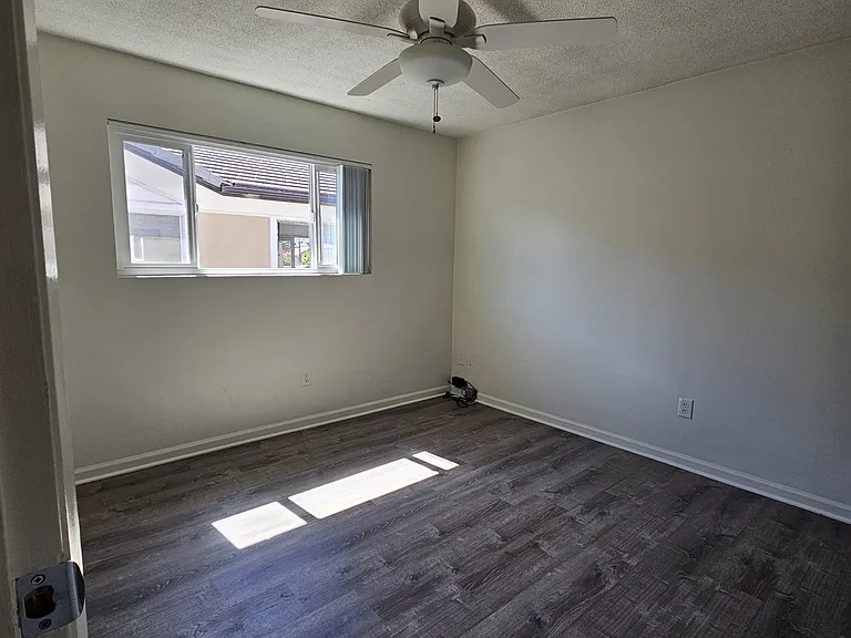 West bedroom with ceiling fan