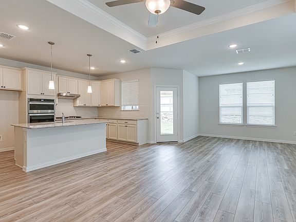 Kitchen and Nook are open to the Family room. Family room features a recessed ceiling and stone fireplace.