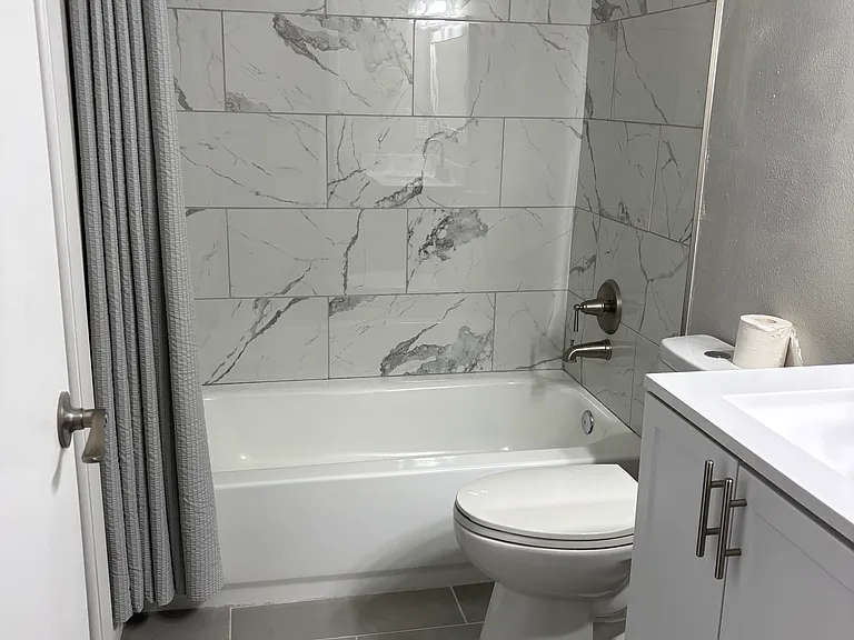 July 2026 updated tub/shower with tile enclosure.
