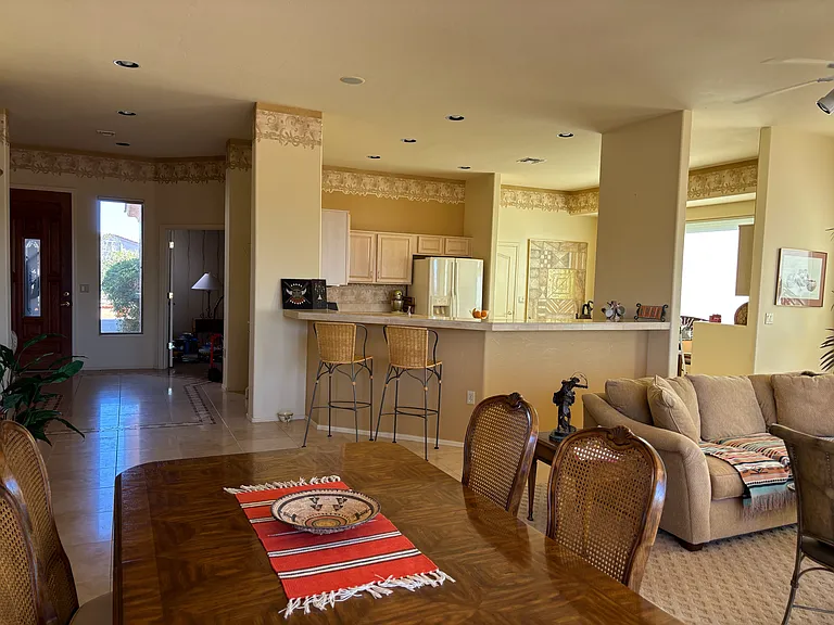 This view shows spacious great room and kitchen. The dining room table can almost double in size.