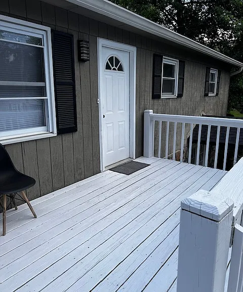Front door to upper story, showing upper deck