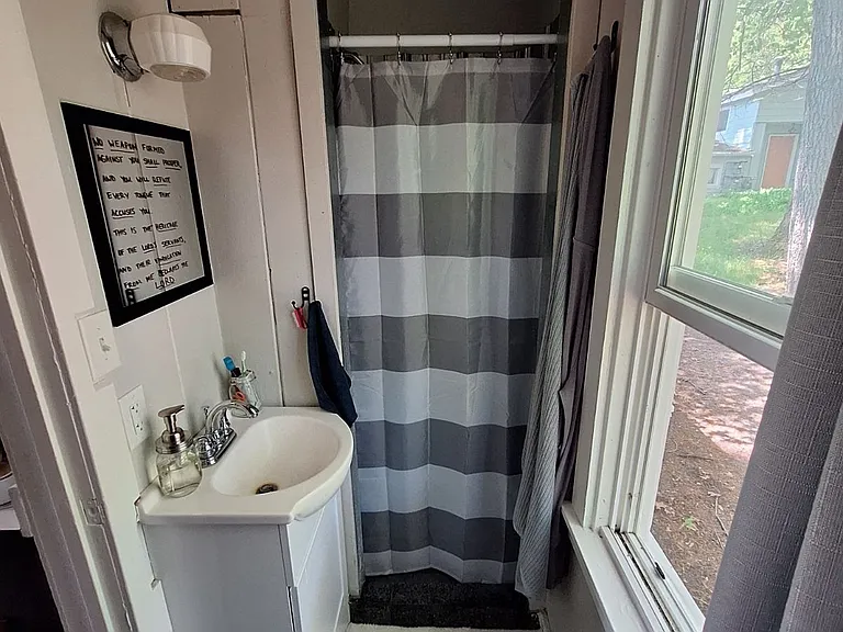 Wide angle bath view sink & shower - Previous resident's furnished view - unit is rented unfurnished
