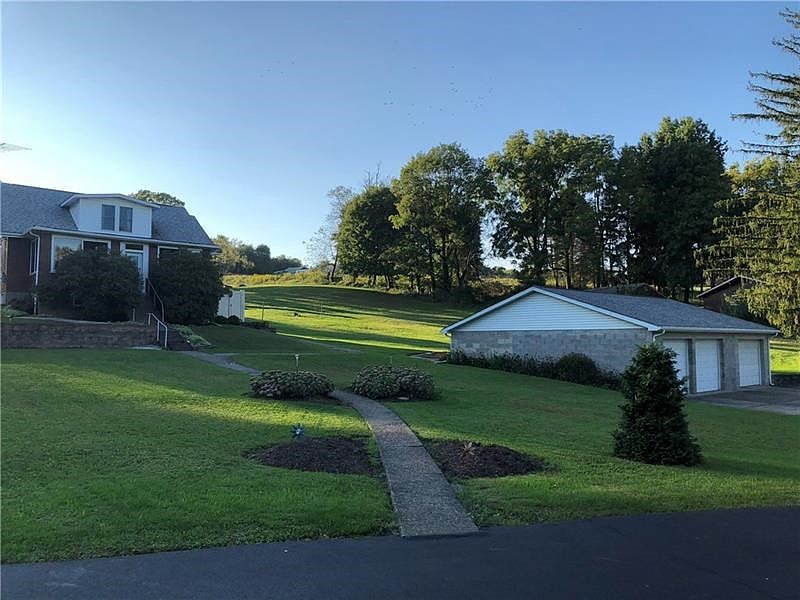 Beautiful 2.3 acre lot with paved/concrete driveway and HUGE 1200+ square foot 3 car garage!