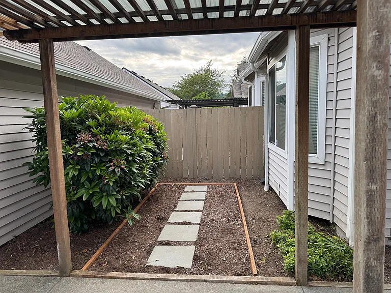 Between the Primary bedroom and garage