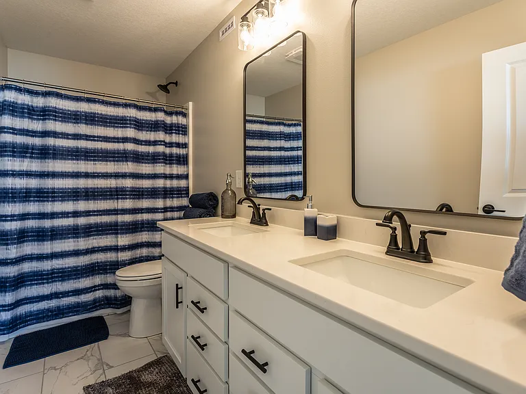 Primary bath featuring double sink vanity. Furniture for staging purposes only, not included.