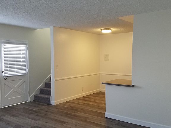 Staircase to second floor and breakfast area outside kitchen