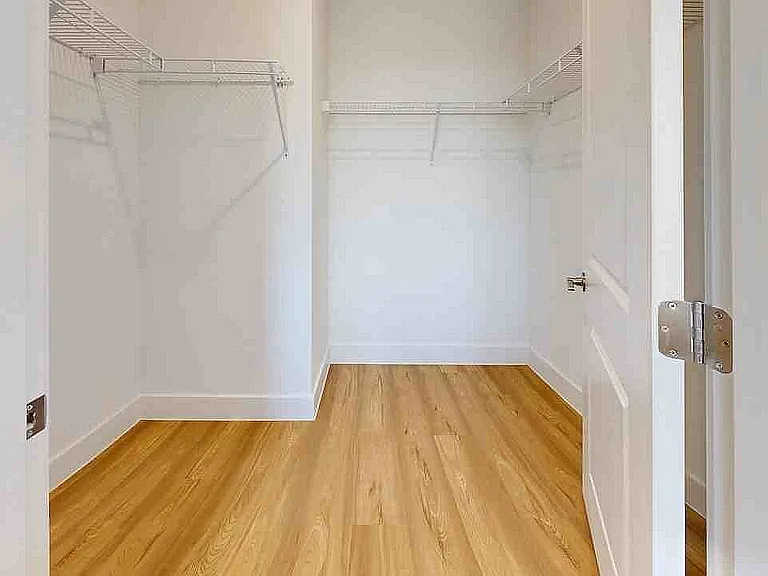 Step into elegance with this expansive walk-in closet, perfect for organizing your wardrobe in style.
