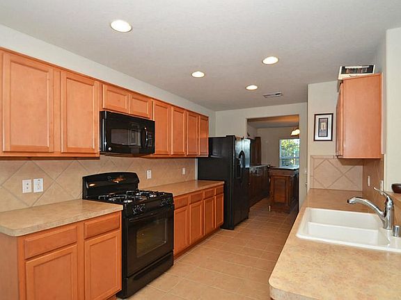  Kitchen has laminate countertops and a ceramic tile backsplash