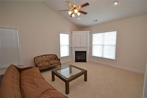 Step inside into this elegant home with a superb great room having a soaring vaulted ceiling, a fantastic corner gas-log fireplace and upgraded neutral carpet.