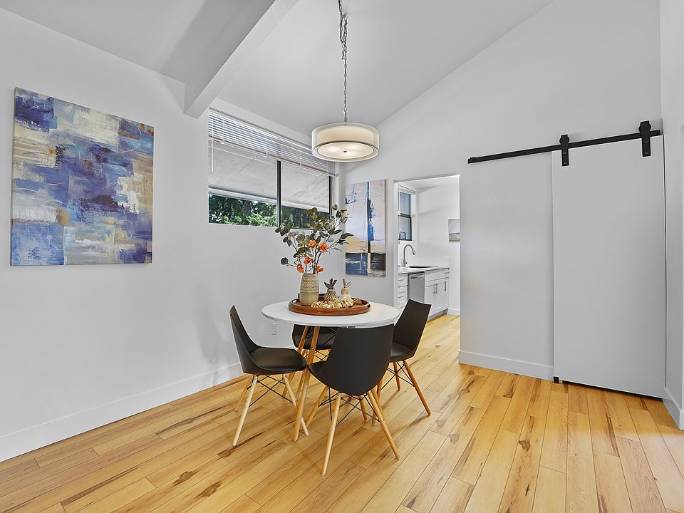 To the left of the main room is the dining area - here shown with small round table but the space can handle a much larger table as well. Ahead is the beautiful kitchen and the barn door covers the large pantry