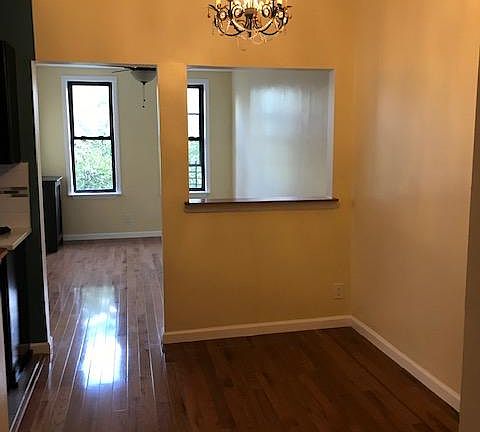 Dining Room w/ a chandelier (kitchen to the left).