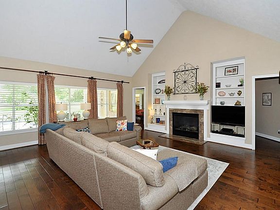 THE ENTRY FOYER ALSO OPENS TO THIS GREAT FAMILY ROOM. THE LARGE WALL OF WINDOWS LOOKS OUT TO THE ACREAGE AND LAKE! WHAT A VIEW!!