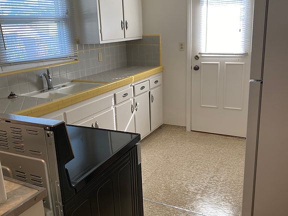 Kitchen with a view of sink, counter & cabinets
